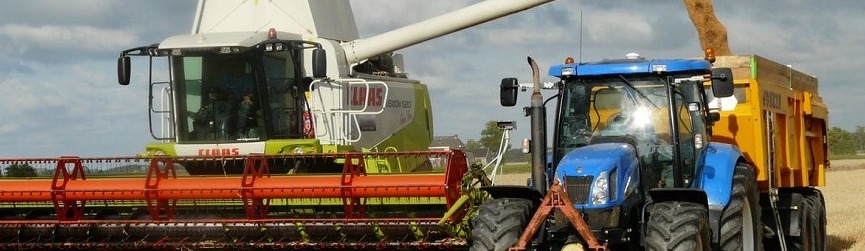 tractor and combine hauling grain