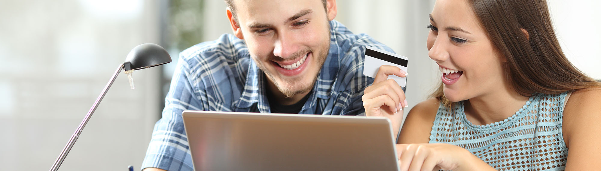 Two people at laptop shopping online.