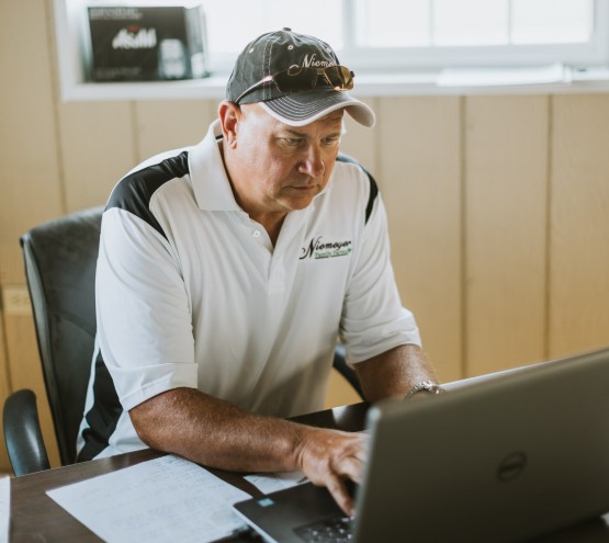 Business owner at his desk checking items on his computer