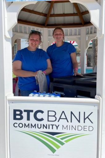Two smiling women working a water booth at the Missouri State Fair
