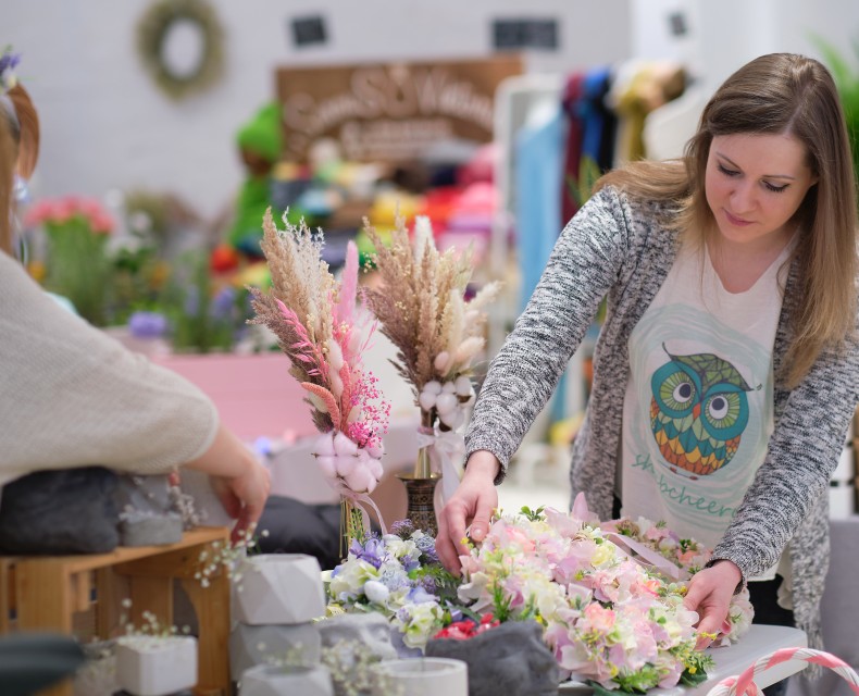 a woman arranging flowers