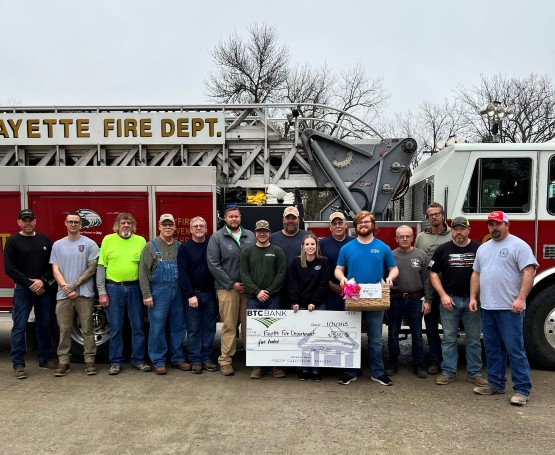 BTC presents a donation check to a local fire department