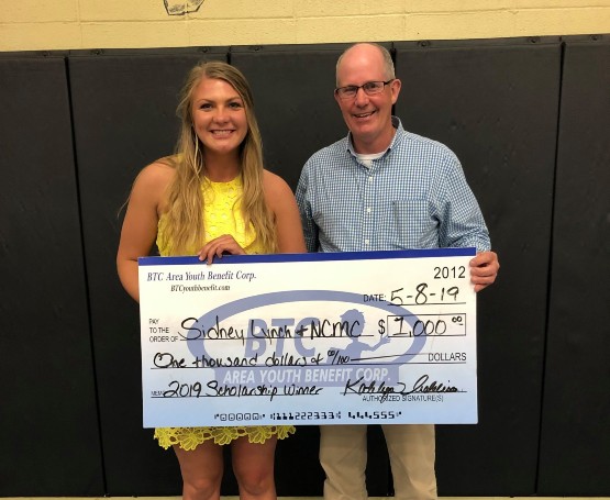 a Scholarship check is presented to Sidney Lynch