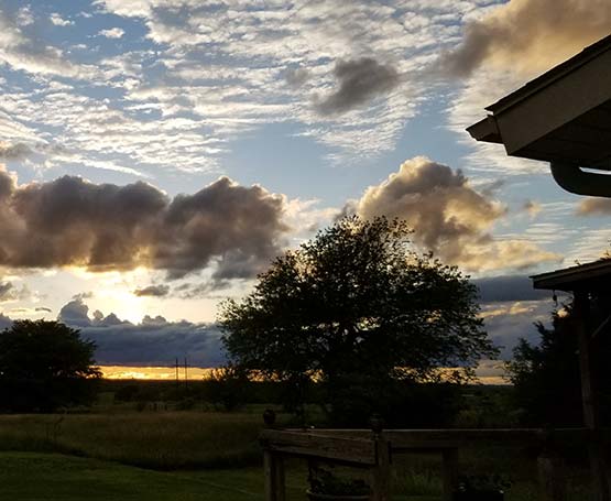 Clouds rolling in over a field.