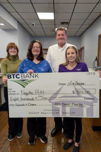 Two BTC Bank employees presenting an oversized check to Fayette R-III representatives for Speech and Drama