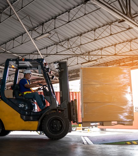 a man drives a forklift