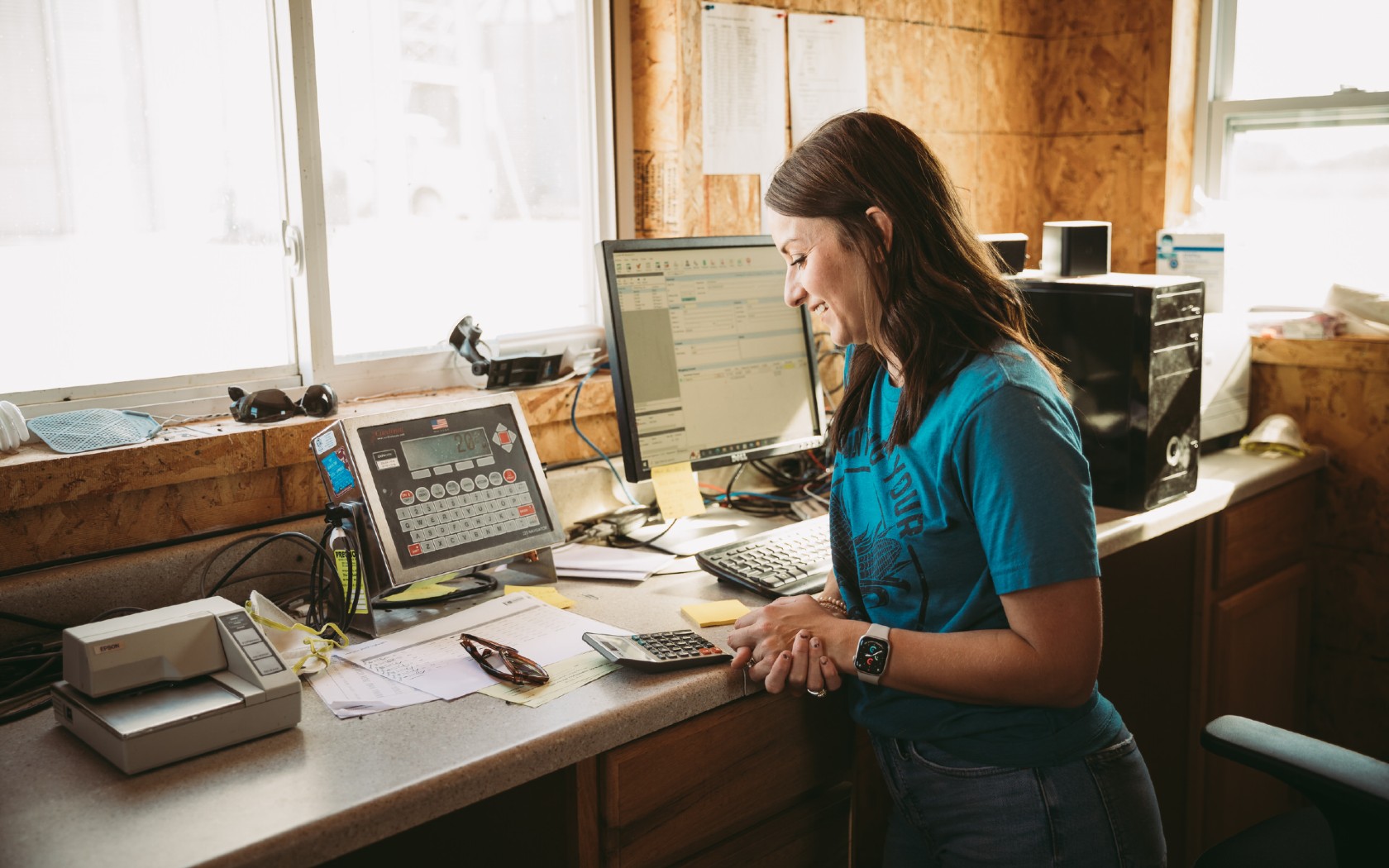a woman looking at numbers on a computer 