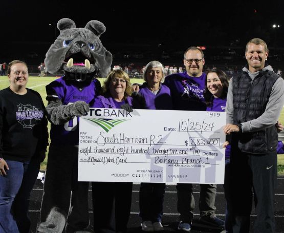 BTC Bank team members and South Harrison R-2 representatives posing for a Mascot Card check donation presentation