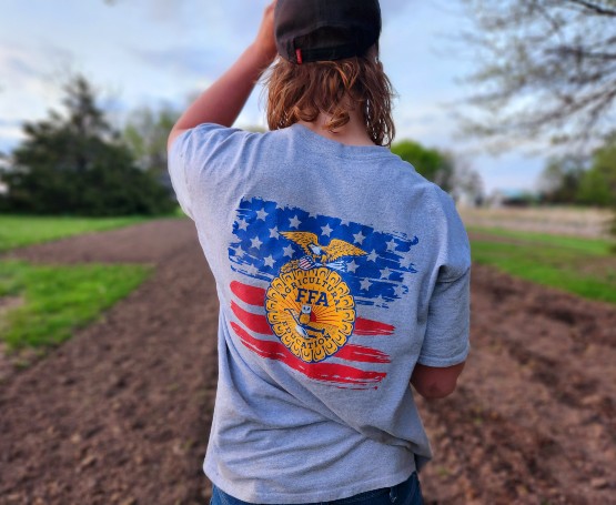 FFA member wearing a FFA shirt while standing in a field