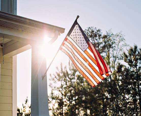 An American flag hanging on someone's house.