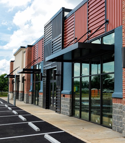 exterior image of a commercial property with several store fronts