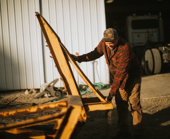 a farmer checks his farme equipment